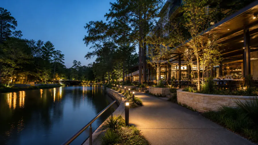 Landscaped waterfront dining in The Woodlands at blue hour